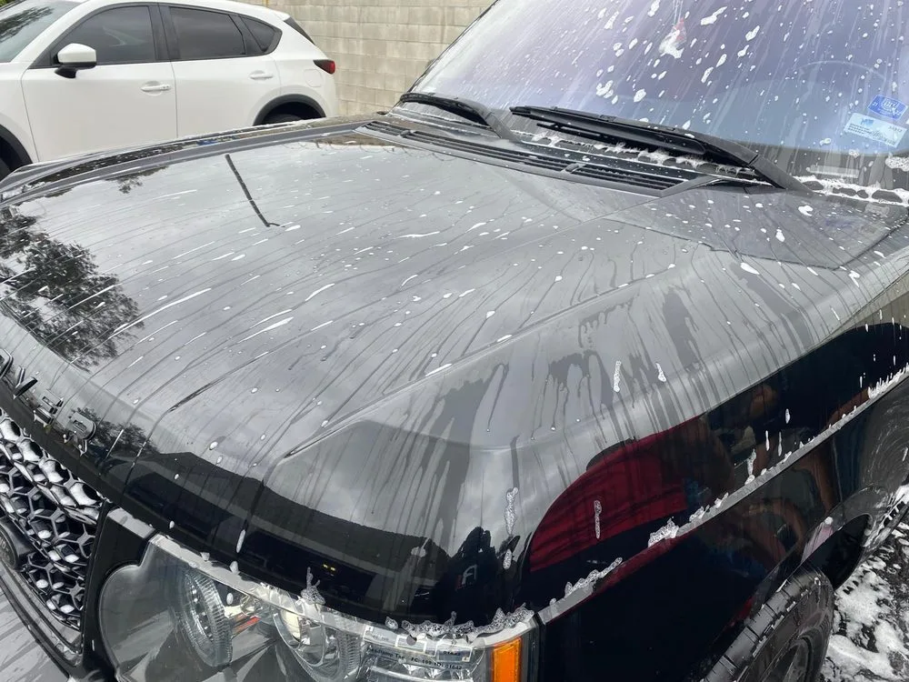 Range Rover covered in snow foam during the decontamination stage